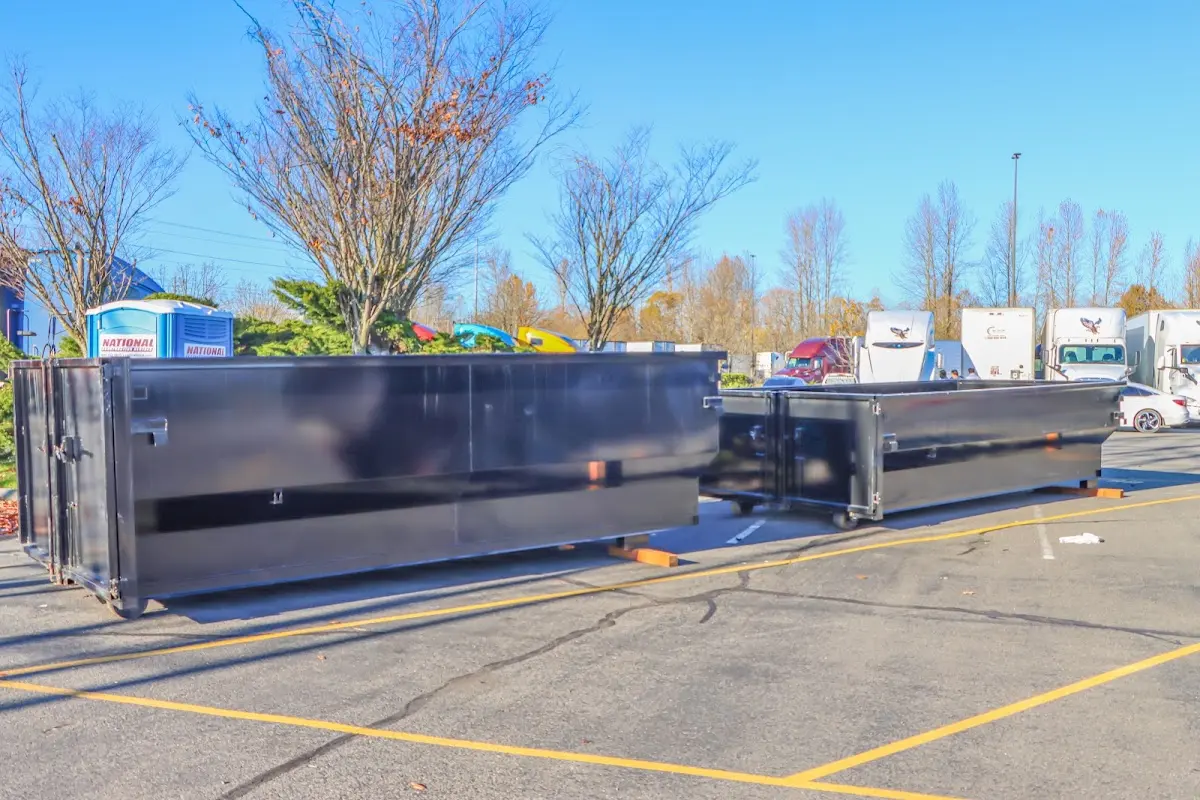 Professional dumpster rental service with roll-off container on residential driveway in Palermo